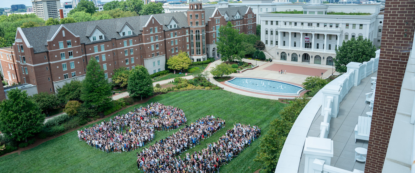 Student standing in the shape of "BU" on main lawn