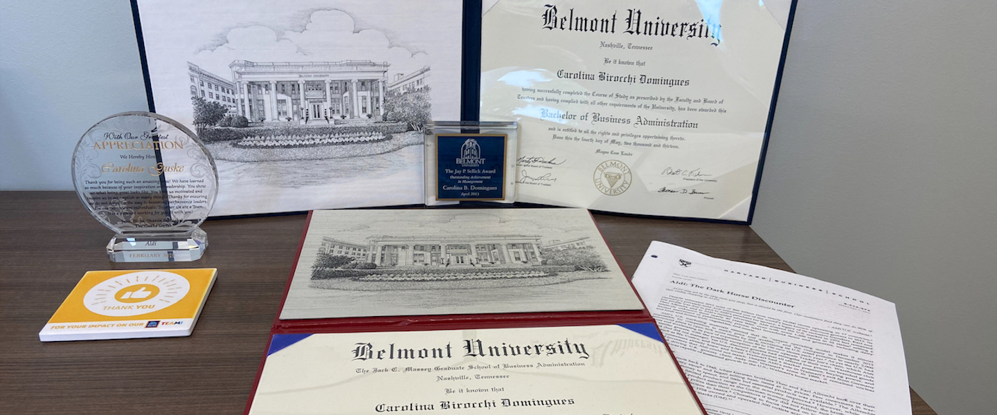 Carolina Guske's diplomas and case study on desk 