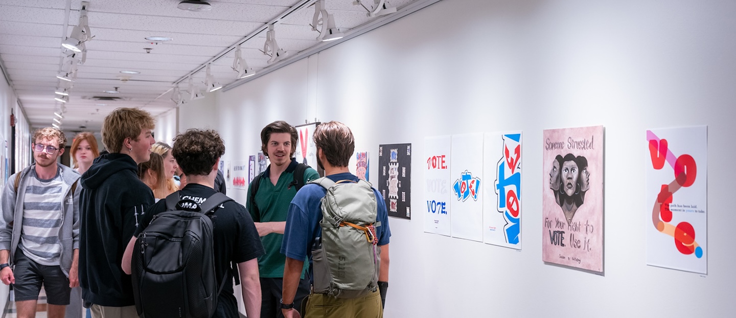 students talk in the gallery