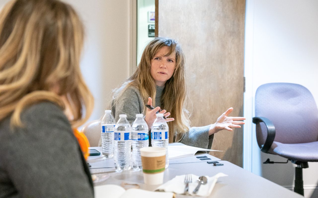 Woman discusses a song idea with her group