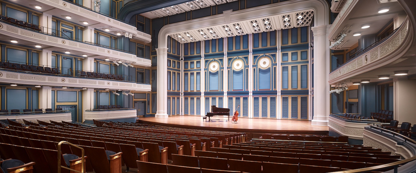 empty Fisher Center auditorium with cello and piano onstage