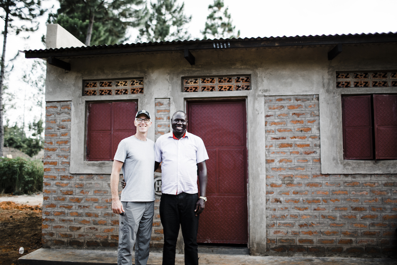 Mike Smalling (left) poses with friend in front of a house