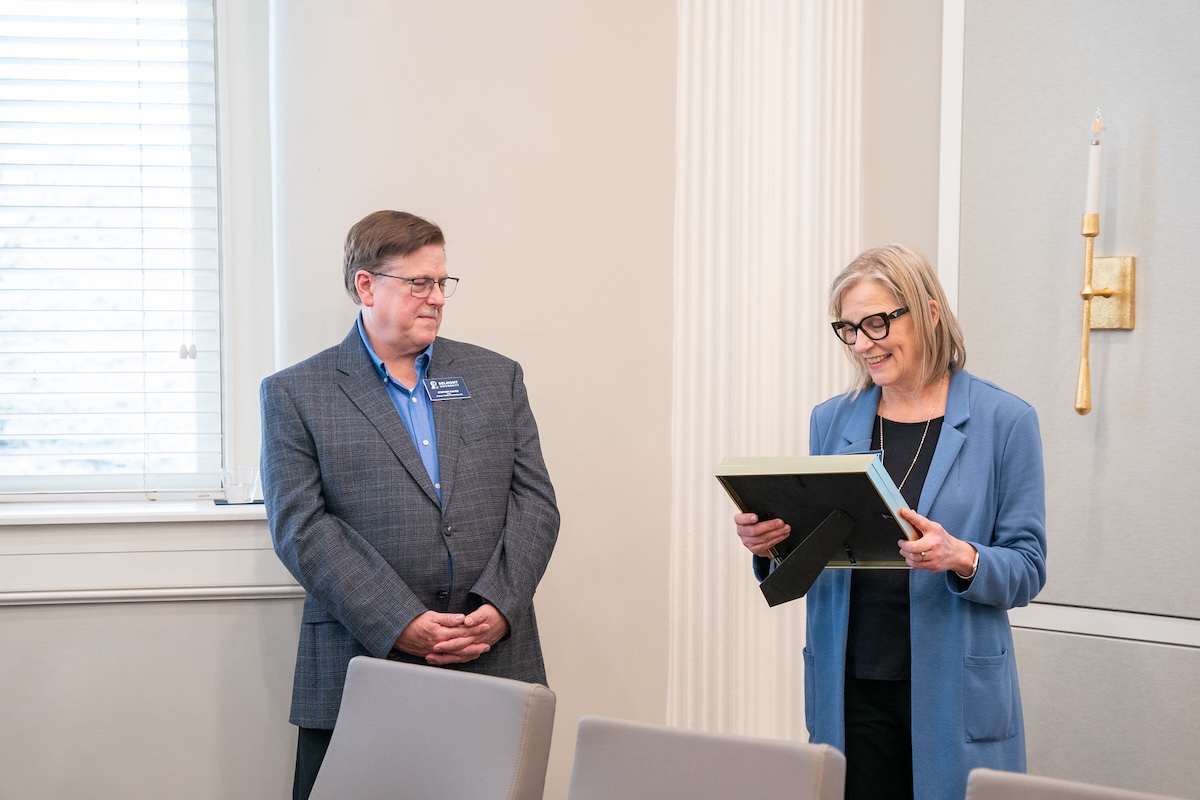 Debbie Sprang reads certificate and Dean Eaves stands by