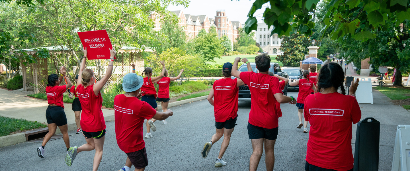 Student leaders swarm a car at move-in day