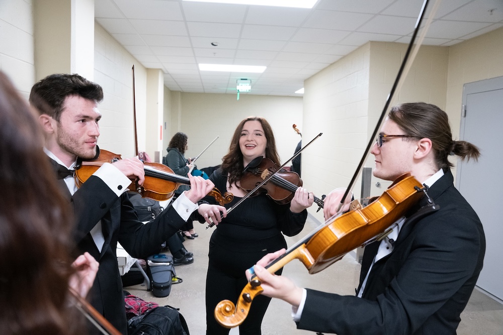 students practicing backstage