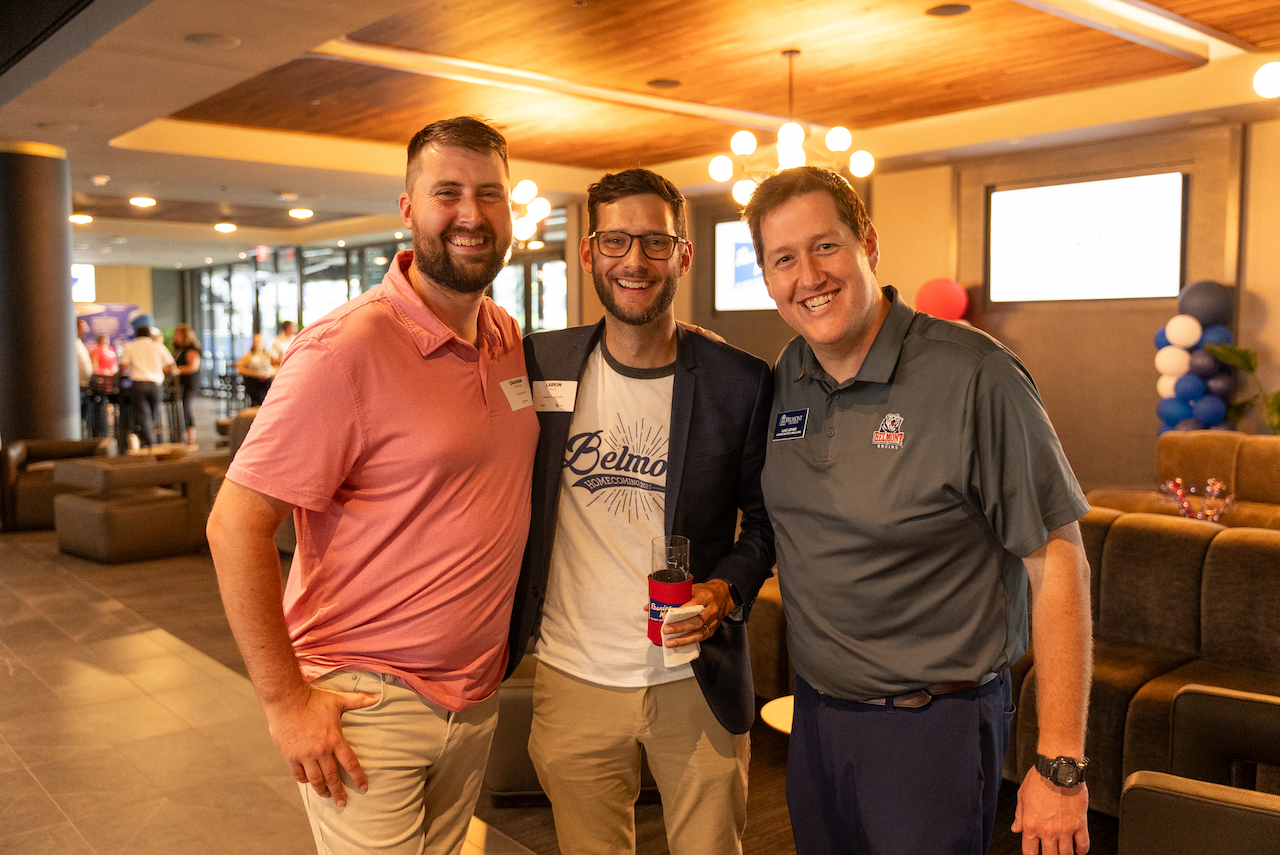 Three males take picture at Reunion Weekend kickoff