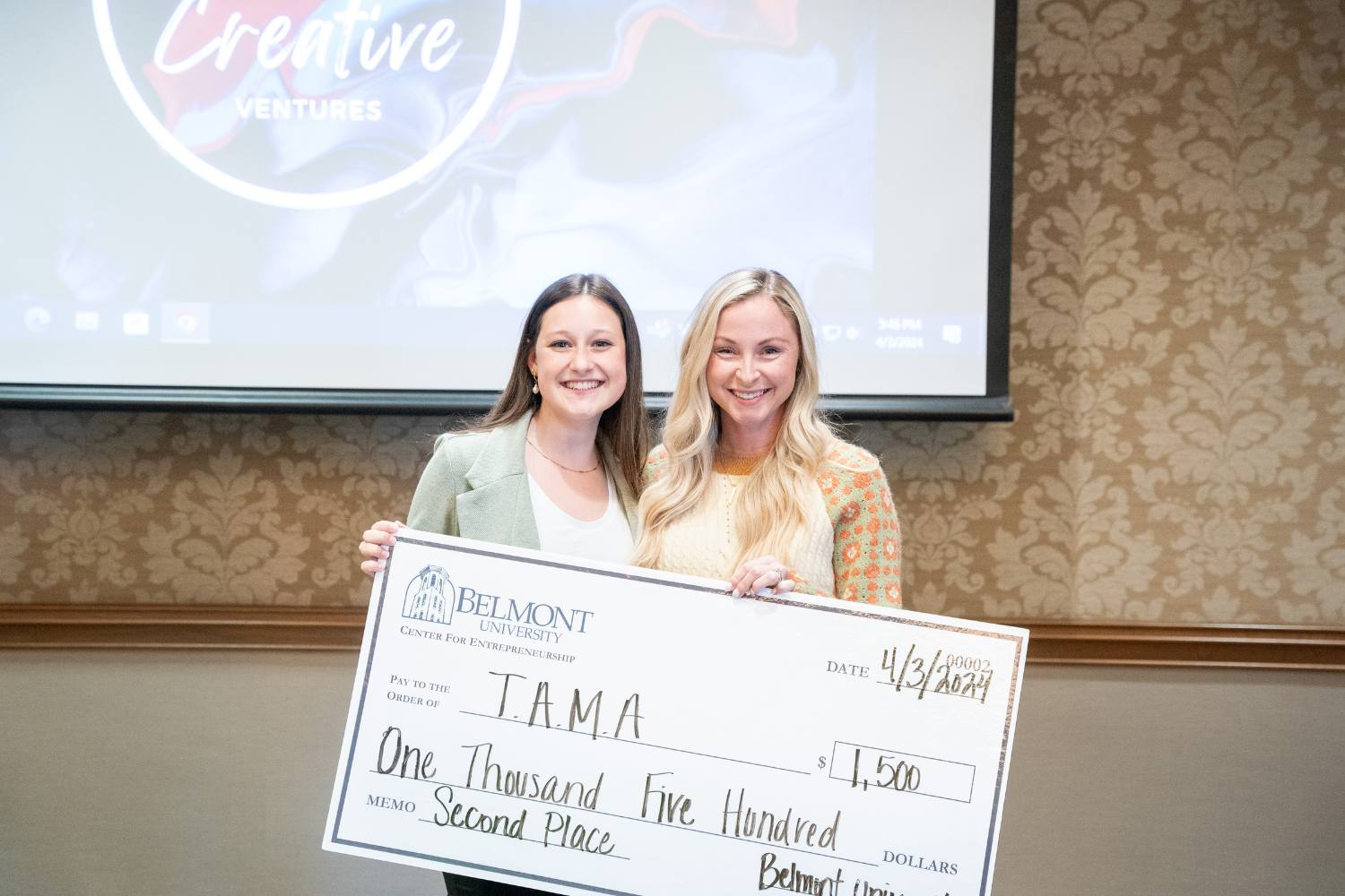 Abby Griffith accepts second-place check from Sarah Moseley