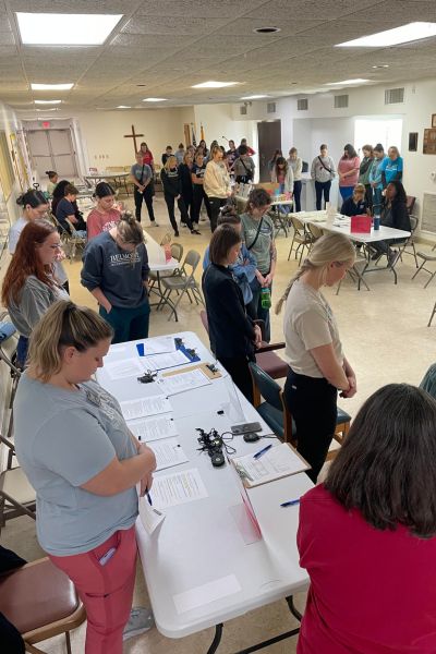 Students praying before a clinic at The Branch