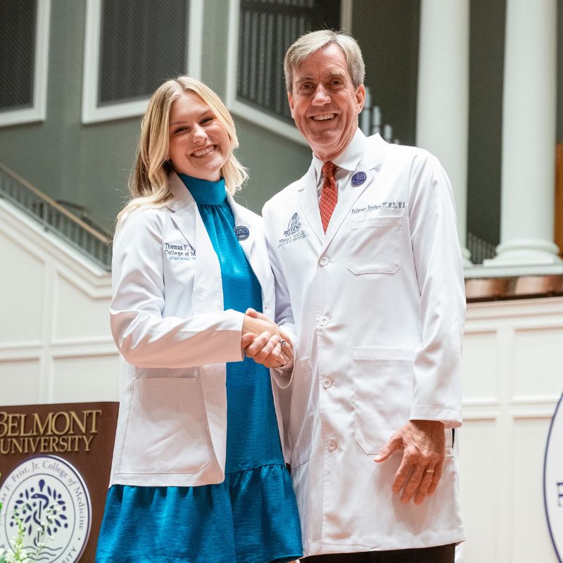 Luce alongside Dean Dr. Anderson Spickard by a podium