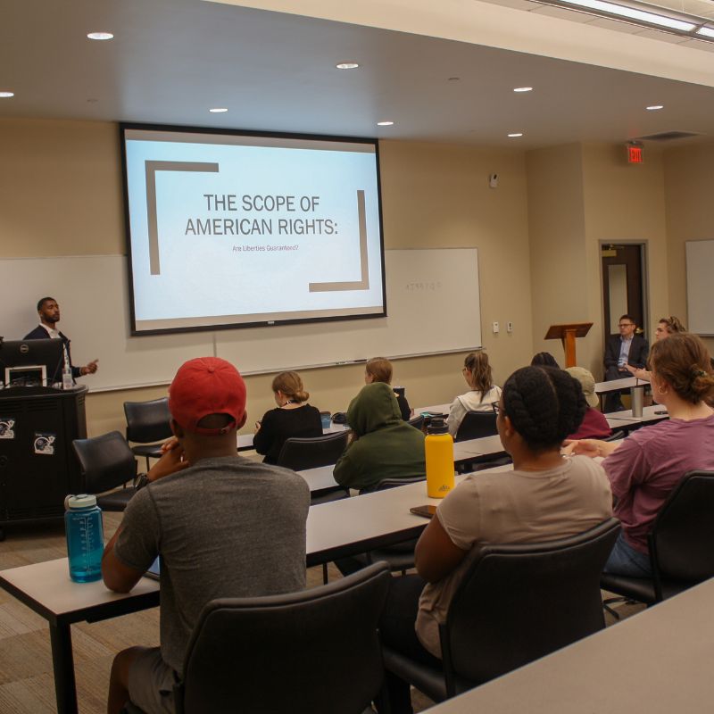 Speaker talks in front of a classroom about the scope of American rights