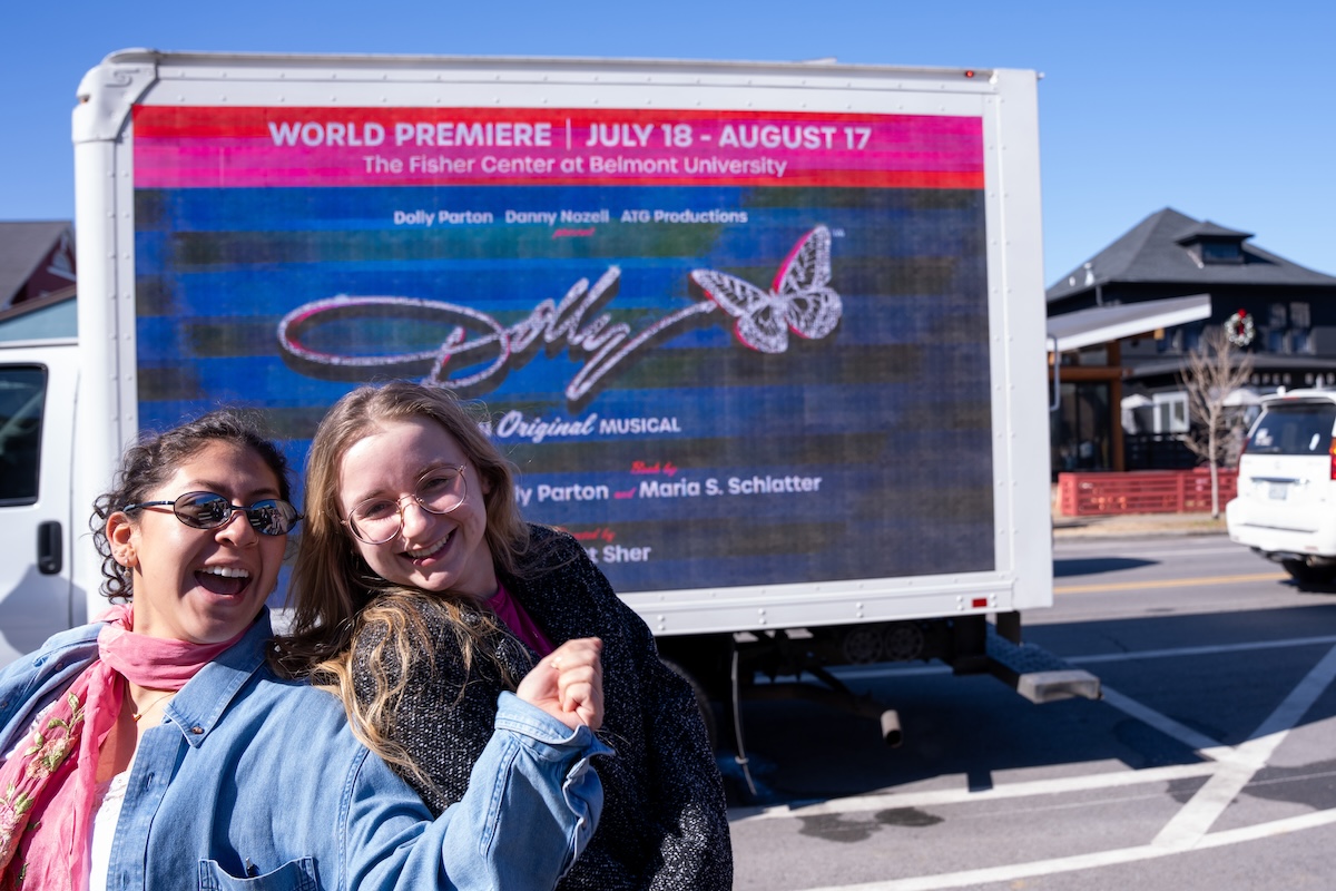 Students in front of Dolly Musical advertisement