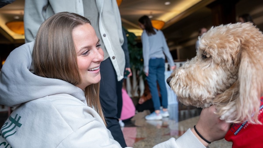 Wilkes on campus with a therapy dog