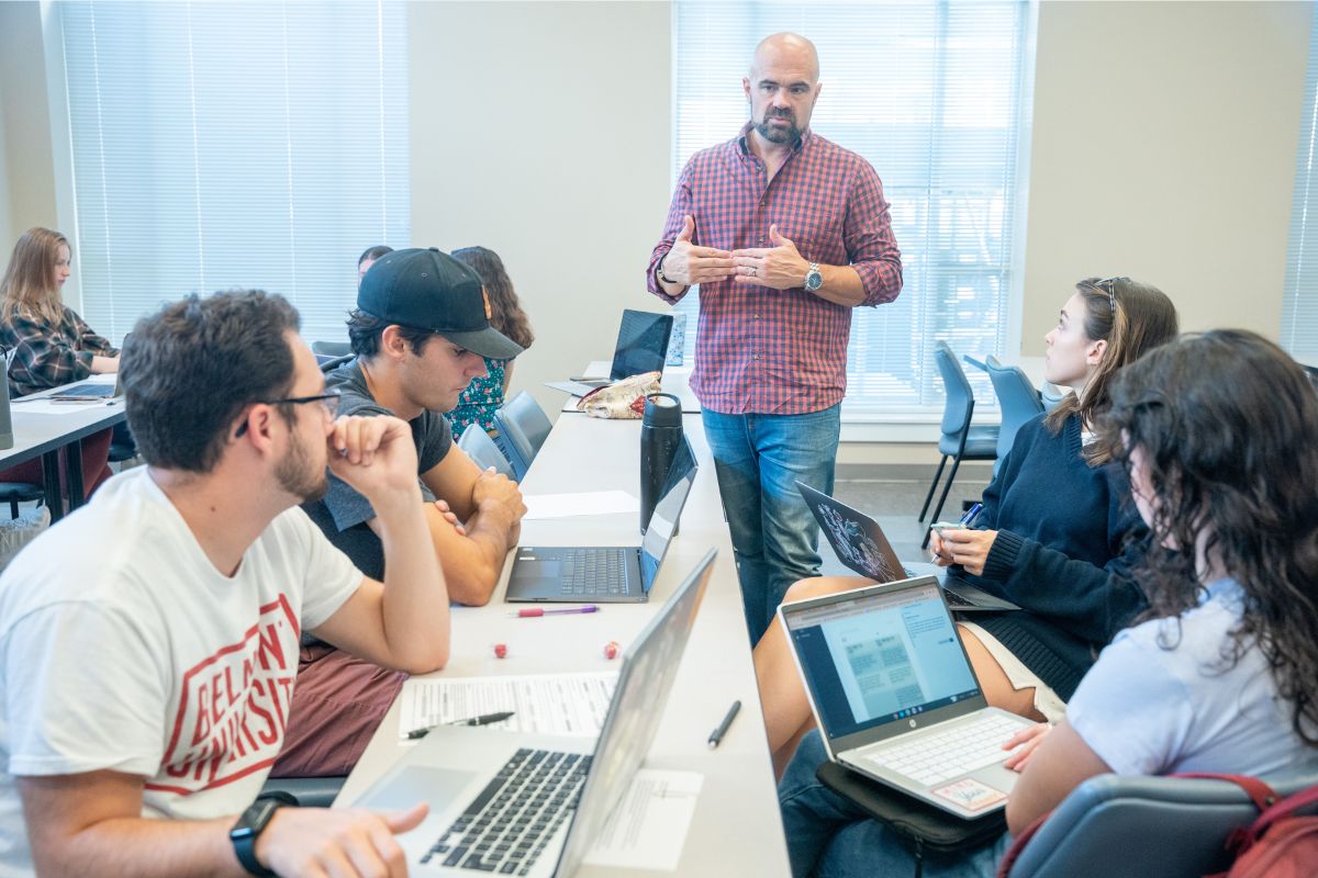 Professor walks through his class and explains a concept to them