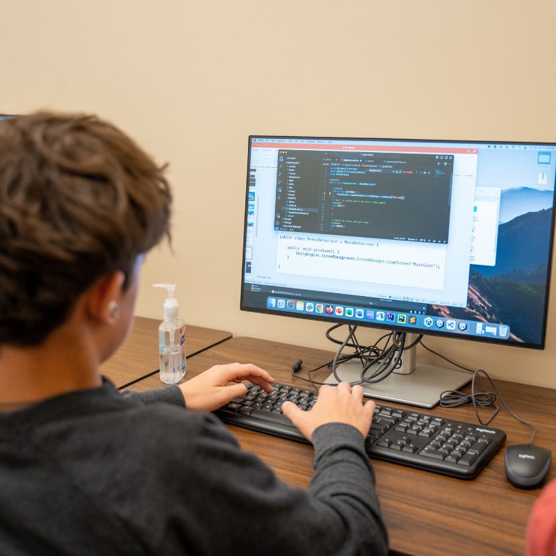 Students at a computer at camp