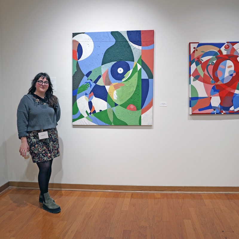 Colvin with her works in the exhibition