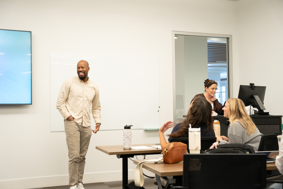 students laughing with a professor