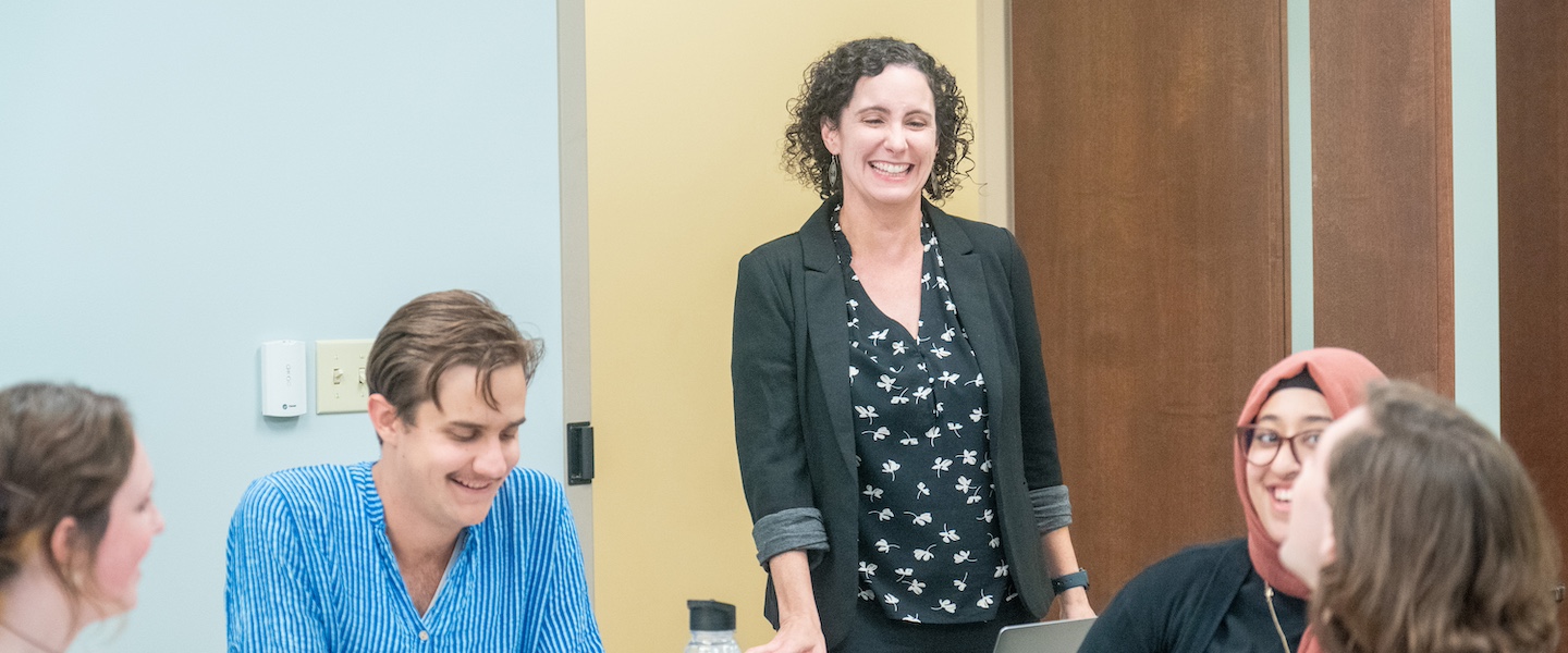 Students laughing with a professor