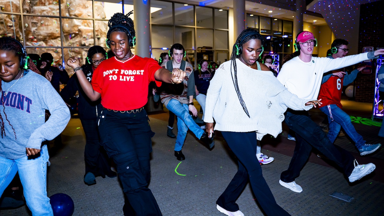 students doing a line dance at a silent disco