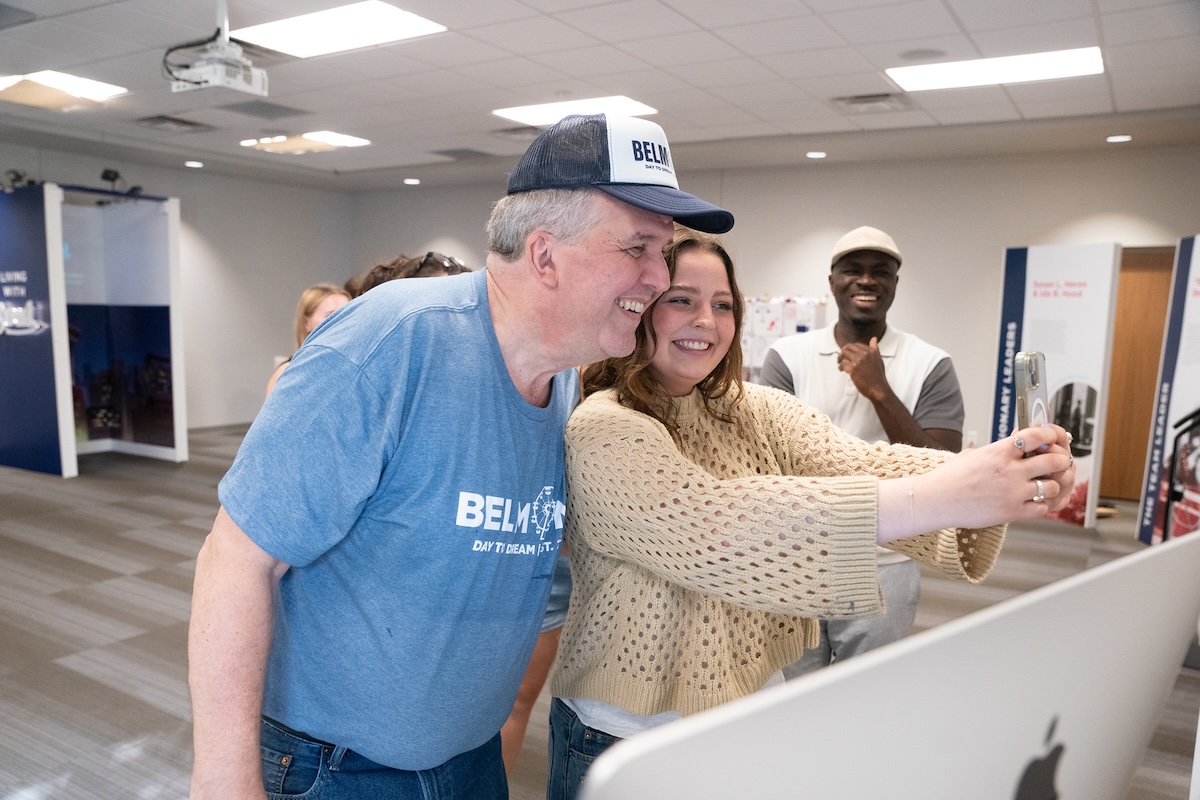 dr jones smiles with a student taking a selfie