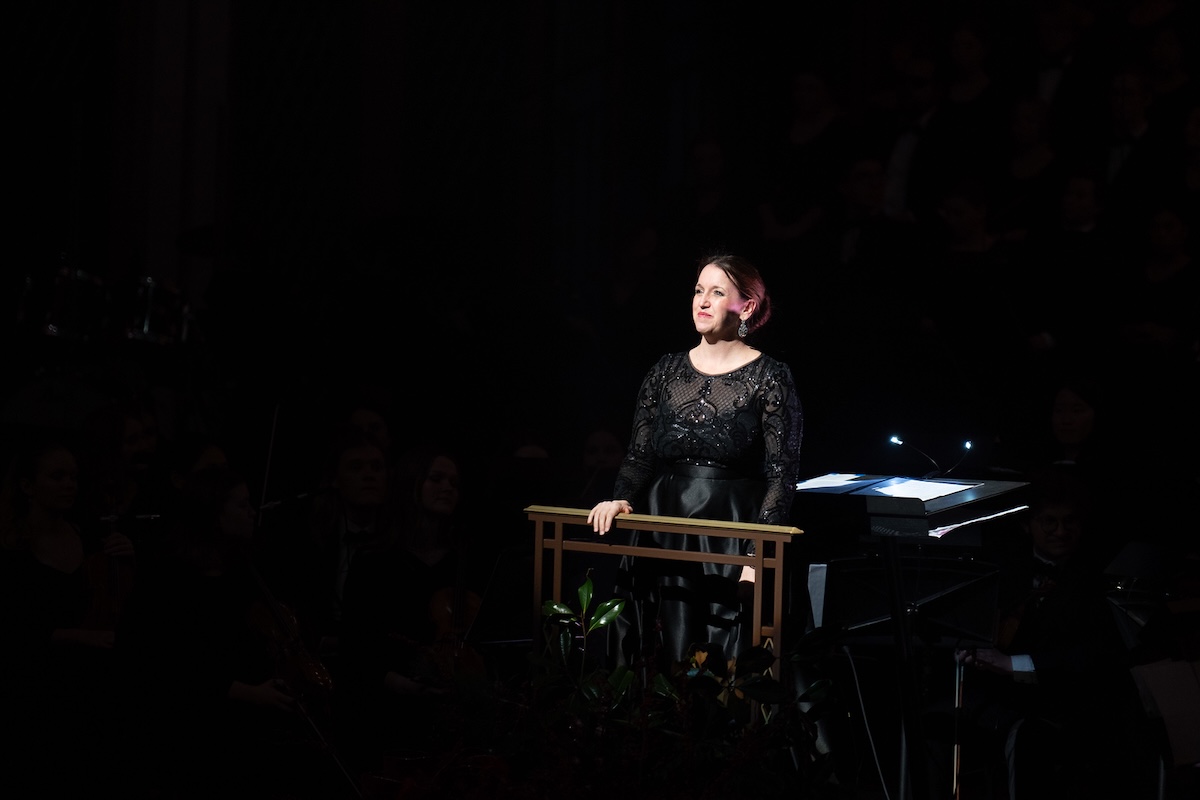 Lesley Mann stands at conductor's stand