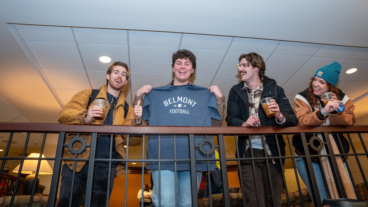 students displaying a parody "Belmont football" t shirt