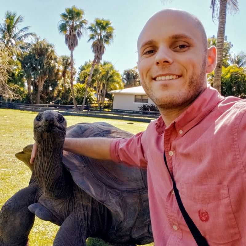 Dr. Chase Kinsey posting with a turtle