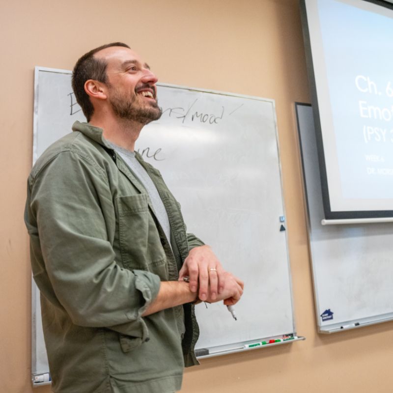 Dr. Patrick Morse in front of a whiteboard