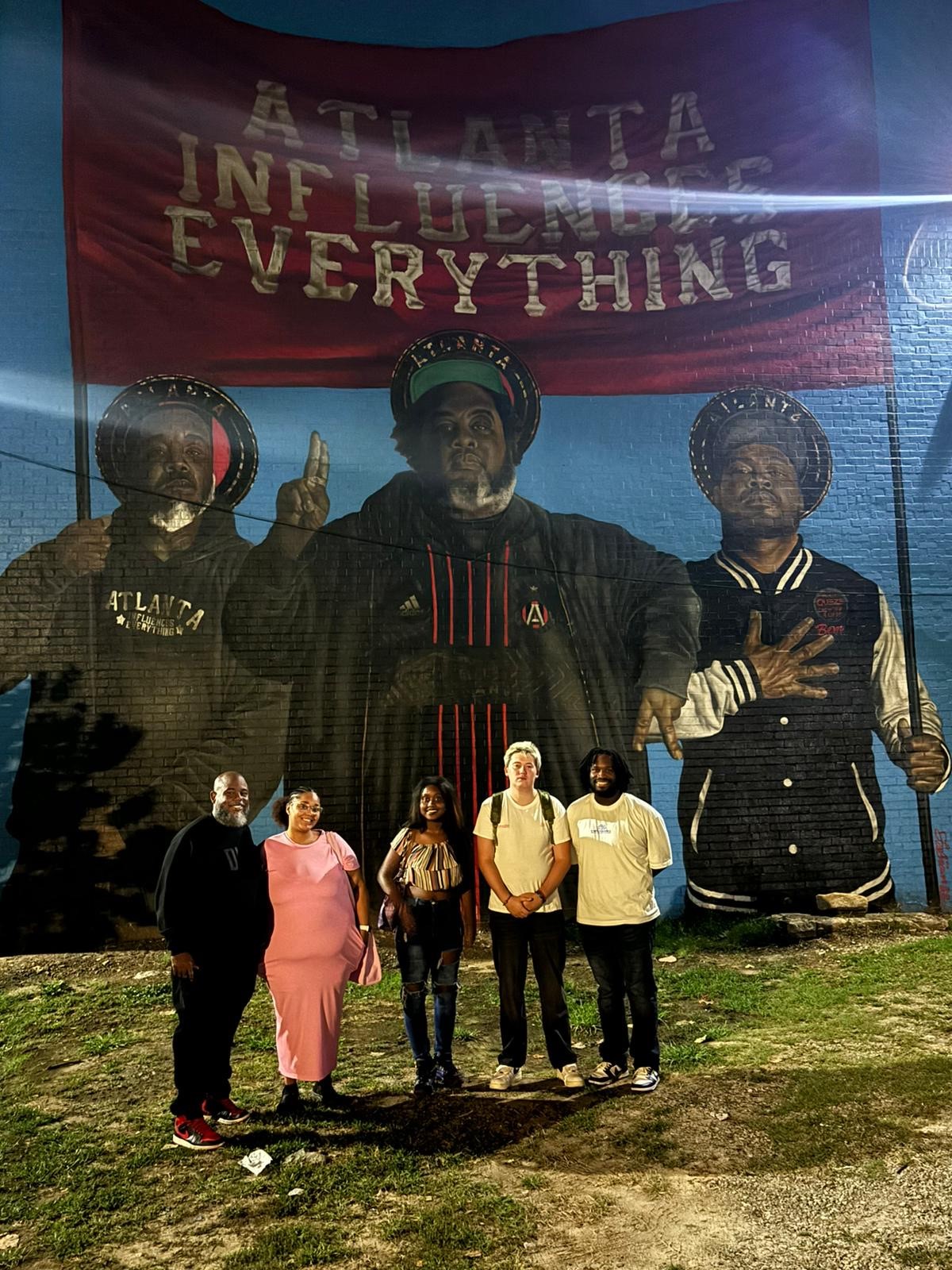 Students standing in front of Atlanta Influences Everything mural. From music to culture to business—Atlanta influences everything! 