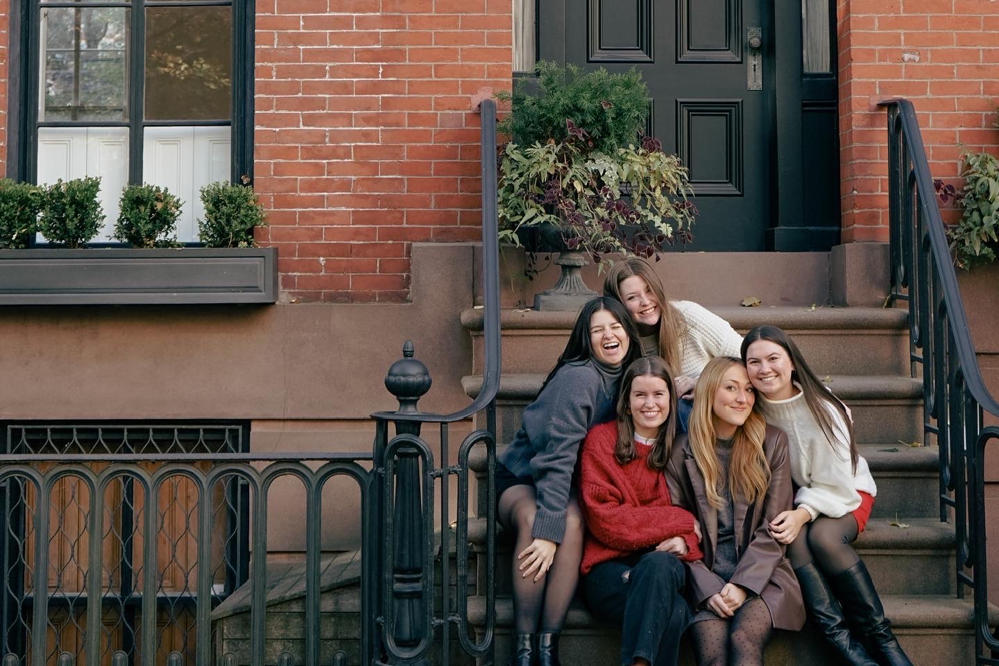 Belmont East students pose for picture on steps of a town house